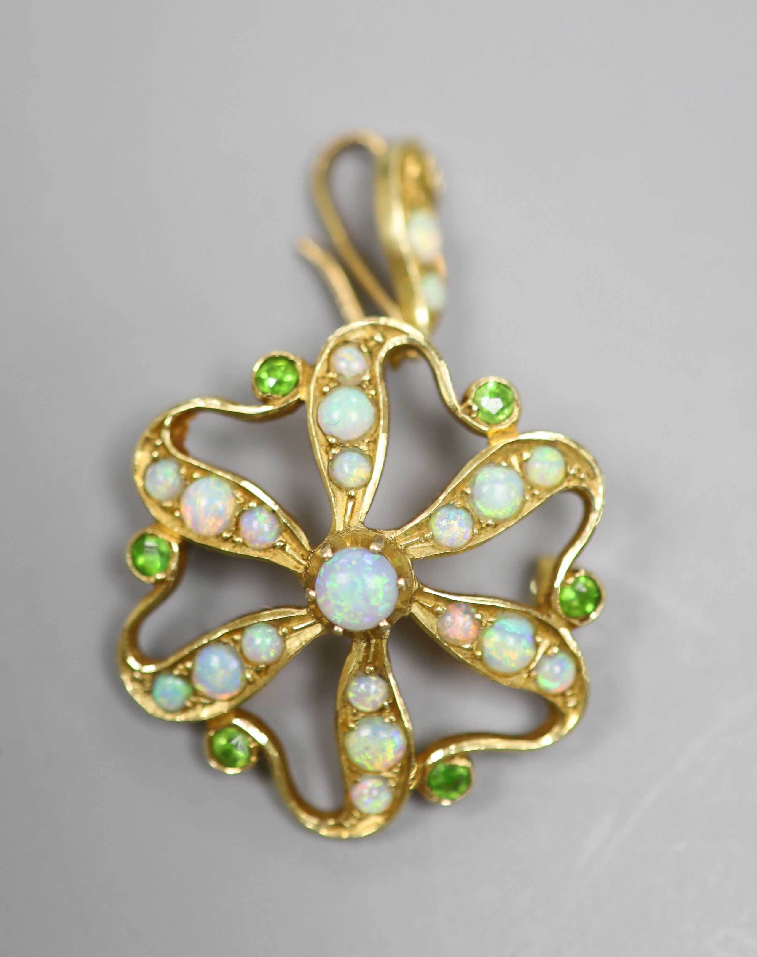 An Edwardian Art Nouveau yellow metal, opal and demantoid garnet cluster set pendant brooch